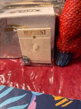 Rucinni brand miniature collectible, specifically a tiny jeweled purse or h